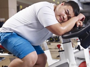 tired-overweight-man-in-blue-shorts-and-white-shirt